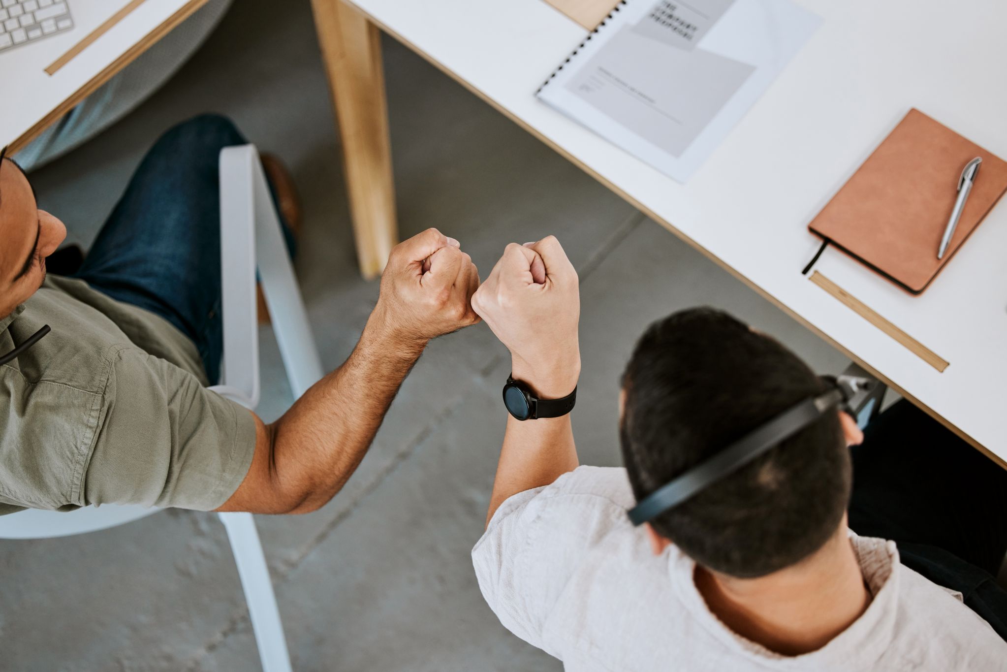 two-workers-fist-bumping
